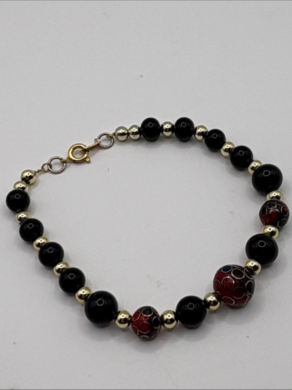 Gold Accent Black Bead Bracelet with Red Cloisonné Beads 7.5”